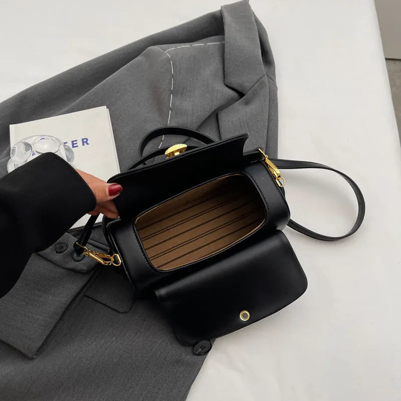 Personalised women's shoulder messenger bag in PU leather, showing letter customisation and stitching detail.