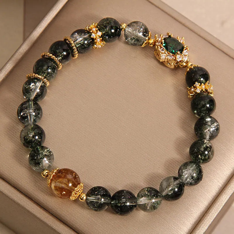 Gold rutilated quartz crystal bracelet with green phantom quartz and visible rutile inclusions