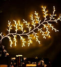 Flexible LED vine garland with warm white lights shaped on a wall for decoration