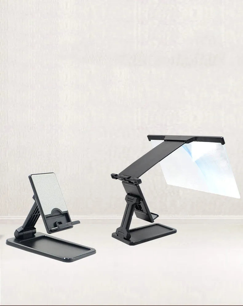 Black folding mobile phone screen magnifier and adjustable holder on a desktop.