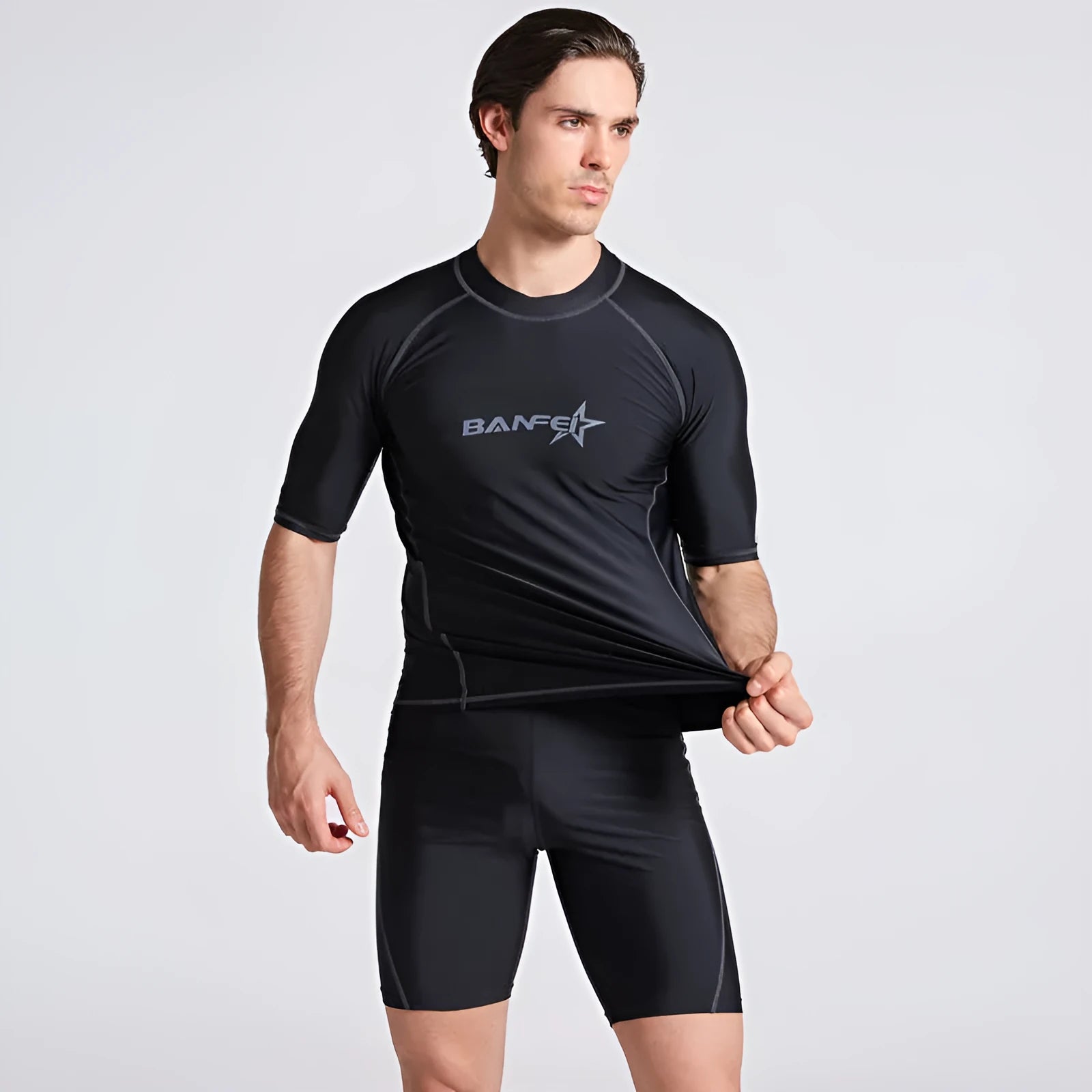 Men's half sleeve nylon swim suit top and pants set on a white background