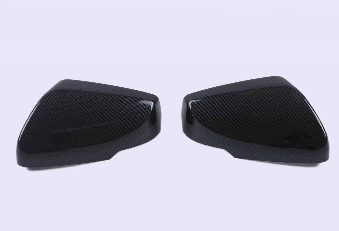 Set of ABS plastic mirror covers for Cadillac CT5 and CT6 in carbon fibre, silver, and rain frame finishes.
