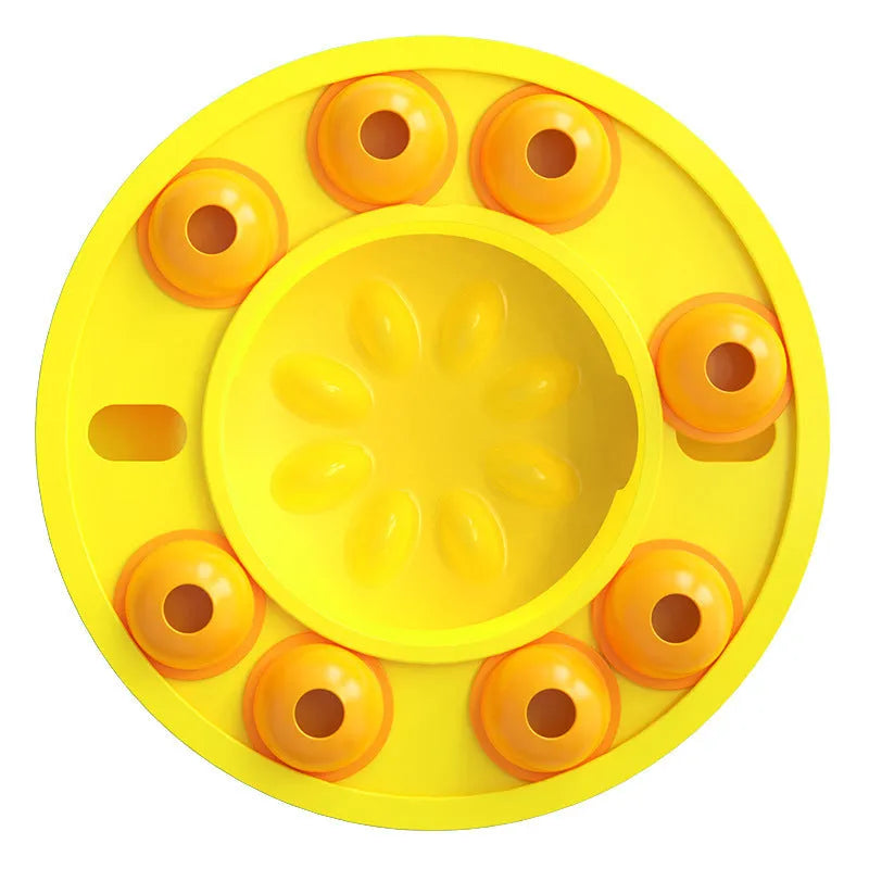 Square green dog puzzle toy with a central feeding well and a rotating turntable lid on a hard floor.