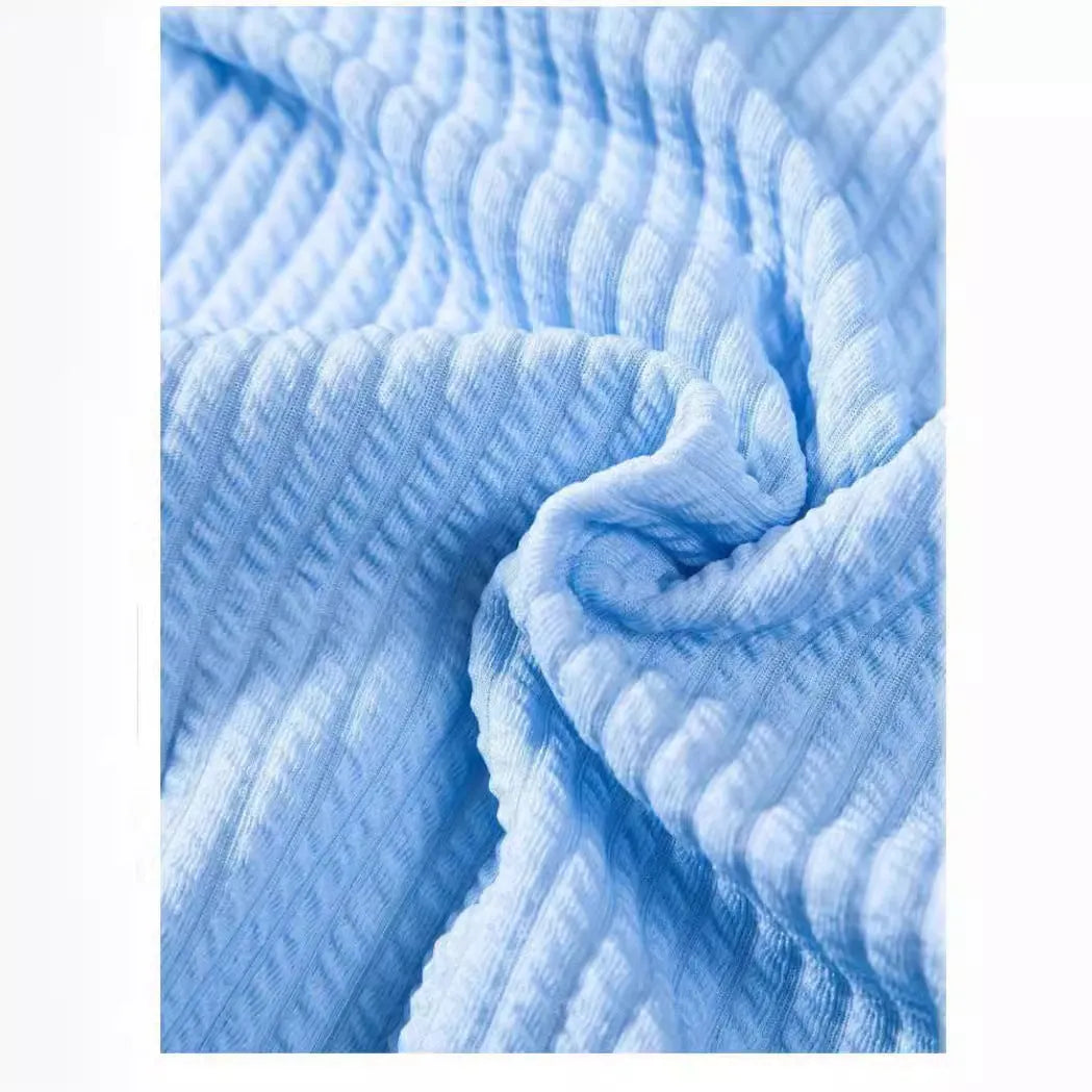 Men's loose fit short sleeve polyester shirt shown in a light blue colour on a hanger.