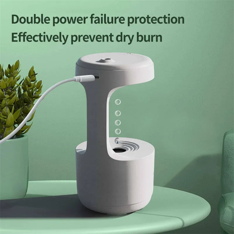 White columnar anti-gravity humidifier on a desk with LED clock display and visible mist.