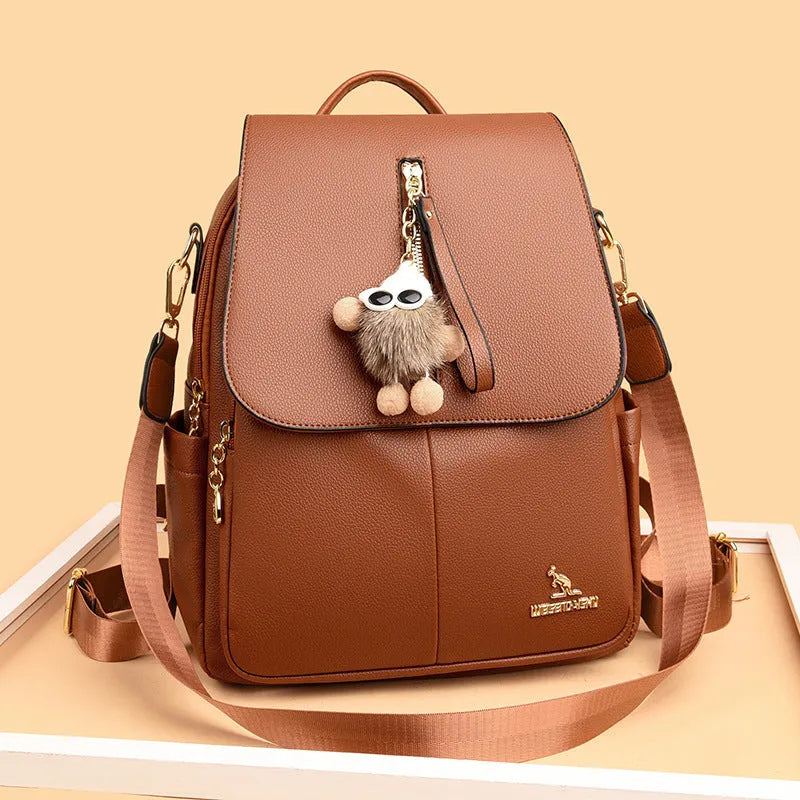 Genuine leather travel backpack with pendant in beige colour for female students, featuring belt decoration and splicing details