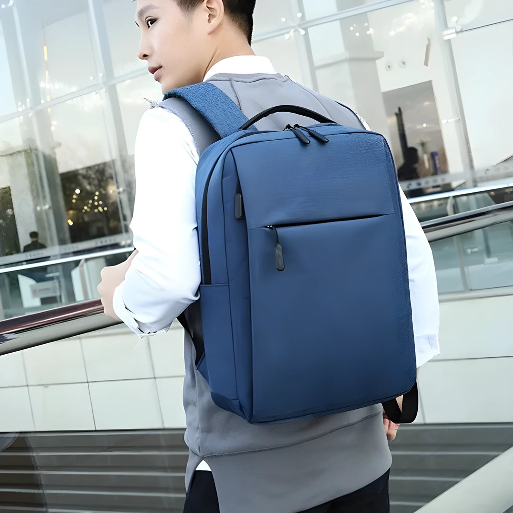 Large expandable Oxford cloth backpack in black with curved shoulder straps and front organisation.