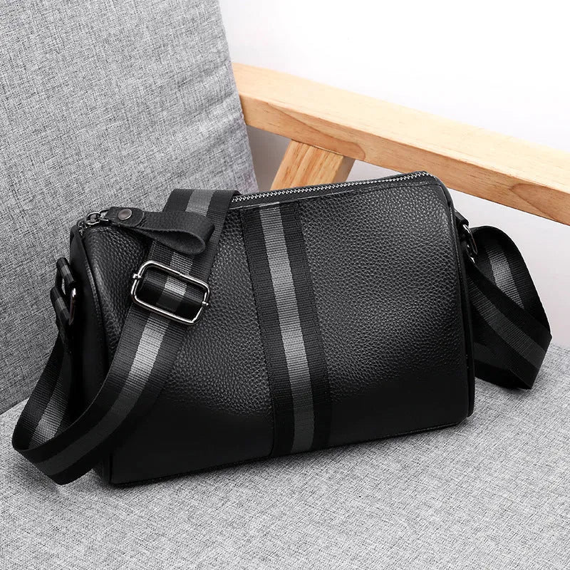 Black genuine leather one-shoulder crossbody bag showing front and interior with polyester lining