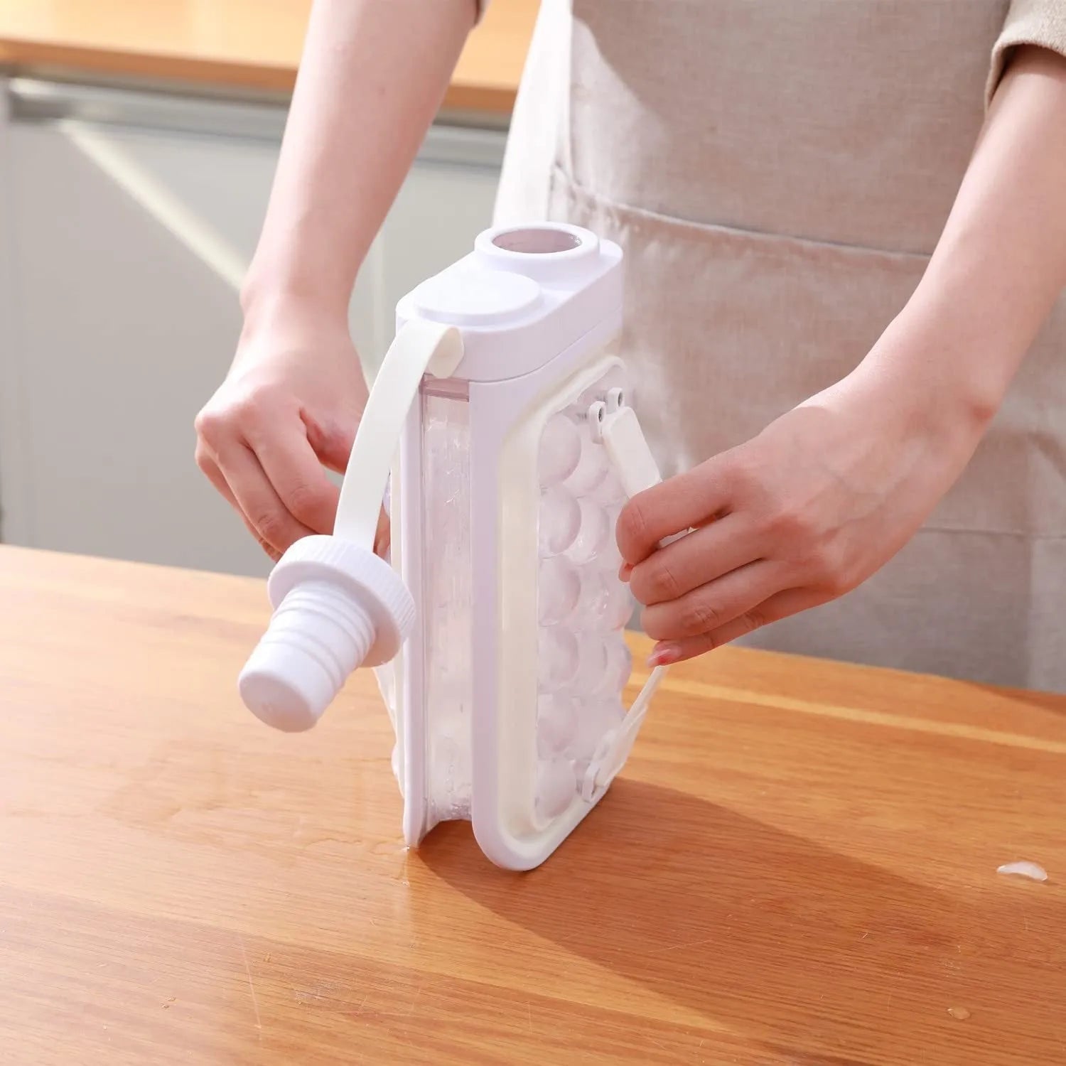 Light blue and white portable ice ball kettle with quick release mould, shown making 17 ice balls.