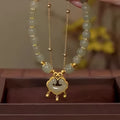 Green women's bracelet with safety lock bell pendant and electroplated mixed materials