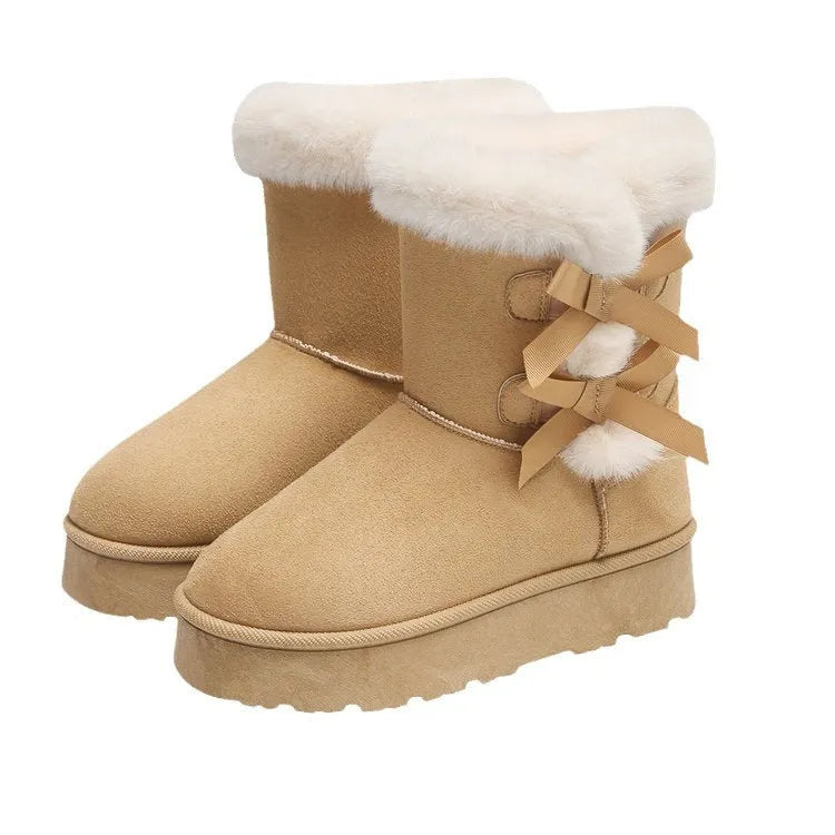Women's suede ankle boots with fleece lining, flat heel, and bow detail in beige