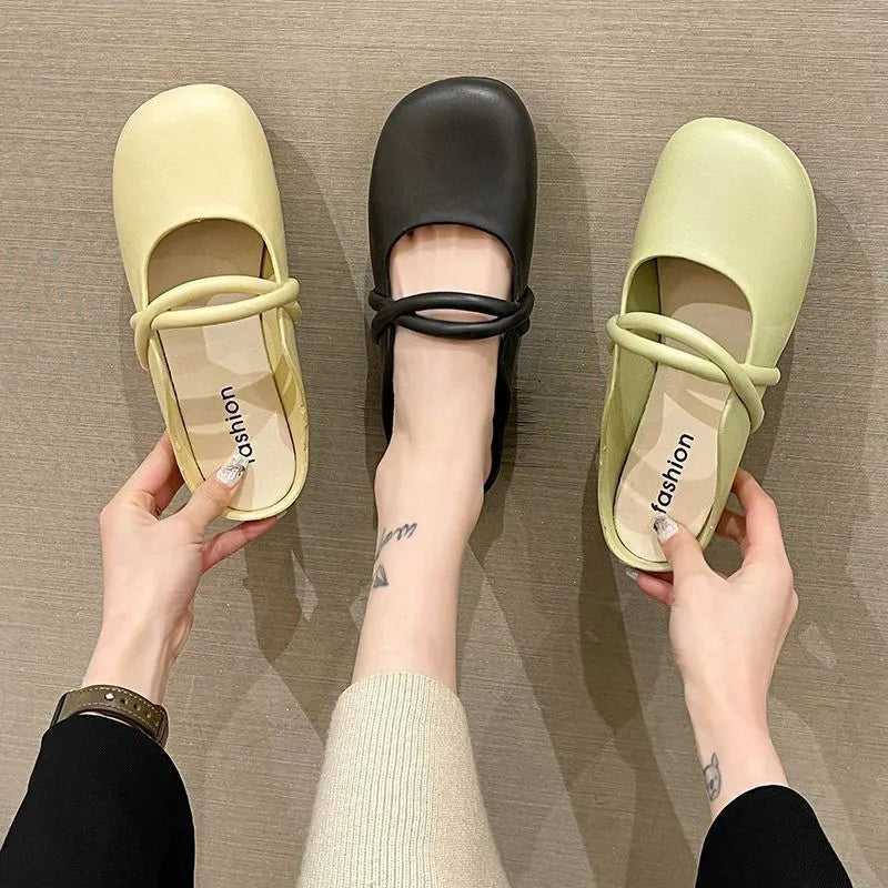 Women's black plastic flip flop sandals with enclosed Baotou front, shown on a white background.