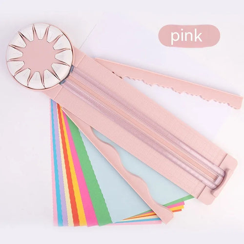 A pink plastic 12-in-1 multifunctional paper cutter with a dotted design on a flat surface.