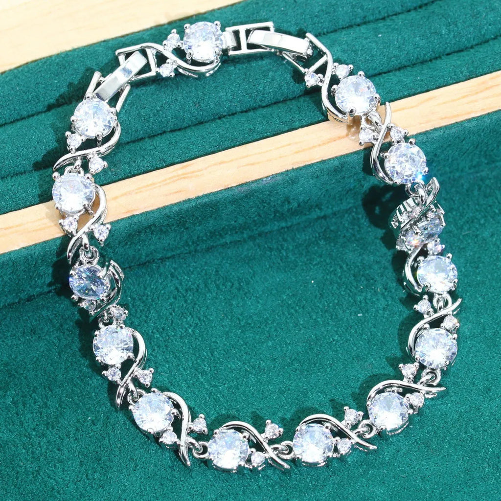 Bridal zircon jewellery four-piece set showing necklace, earrings, bracelet and ring with water wave chain