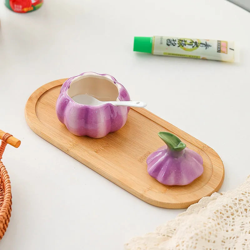 Ceramic onion seasoning jar with cover and spoon in modern simplicity style on a kitchen countertop