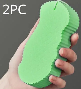 White 3D fish scale pattern bath sponge with hang loop on a bathroom background.