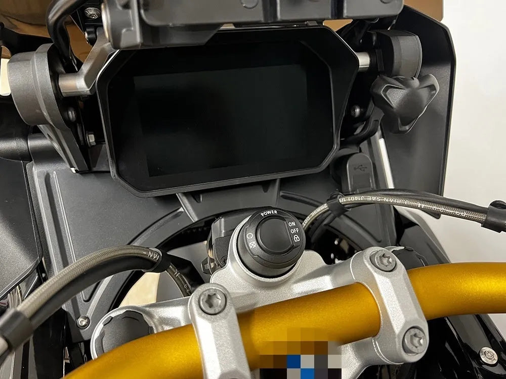 Black ABS plastic cockpit fairing mounted on a BMW R1250GS motorcycle, showing integrated design.