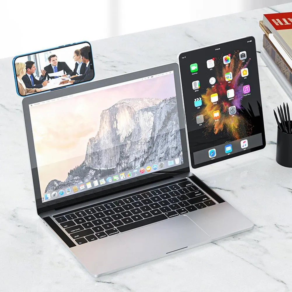Black aluminium magnetic phone holder clipped to side of a silver laptop.