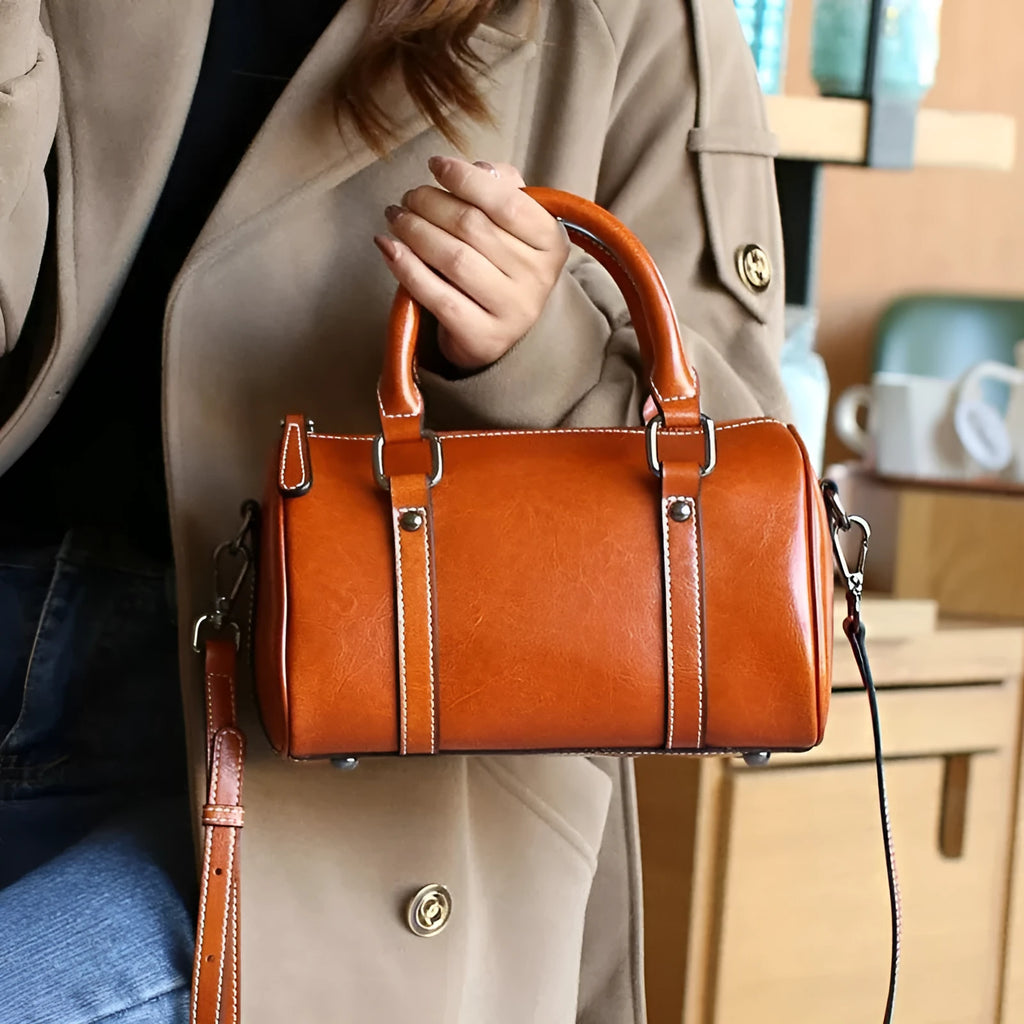 Cortex lady casual zip crossbody bag in top grain leather, cylindrical shape, shown in available colours