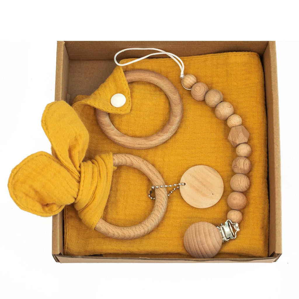 Baby teething gift set with bamboo gauze blanket, wooden chewing ring, woven bell, and developmental toys