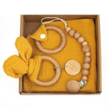 Baby teething gift set with bamboo gauze blanket, wooden chewing ring, woven bell, and developmental toys