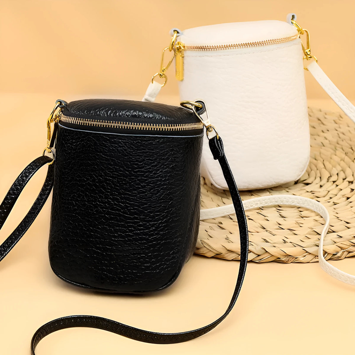 Genuine leather small crossbody bag in black with adjustable strap and shell shape design