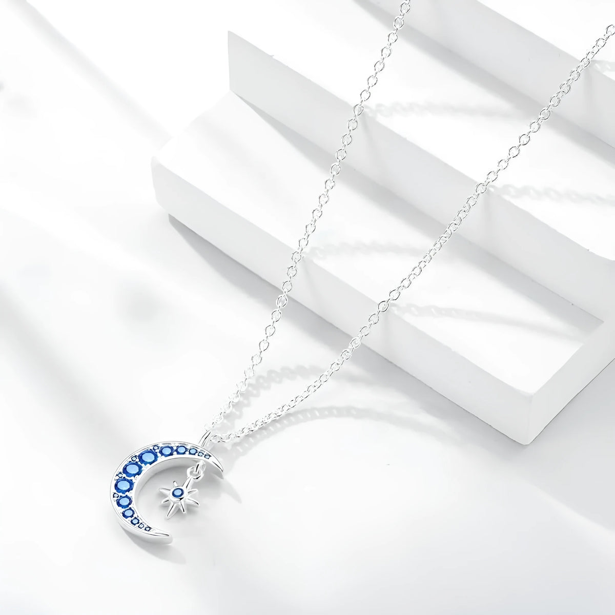 Blue moon pendant necklace with copper geometric pendant, white gold colour finish, and adjustable O-ring chain