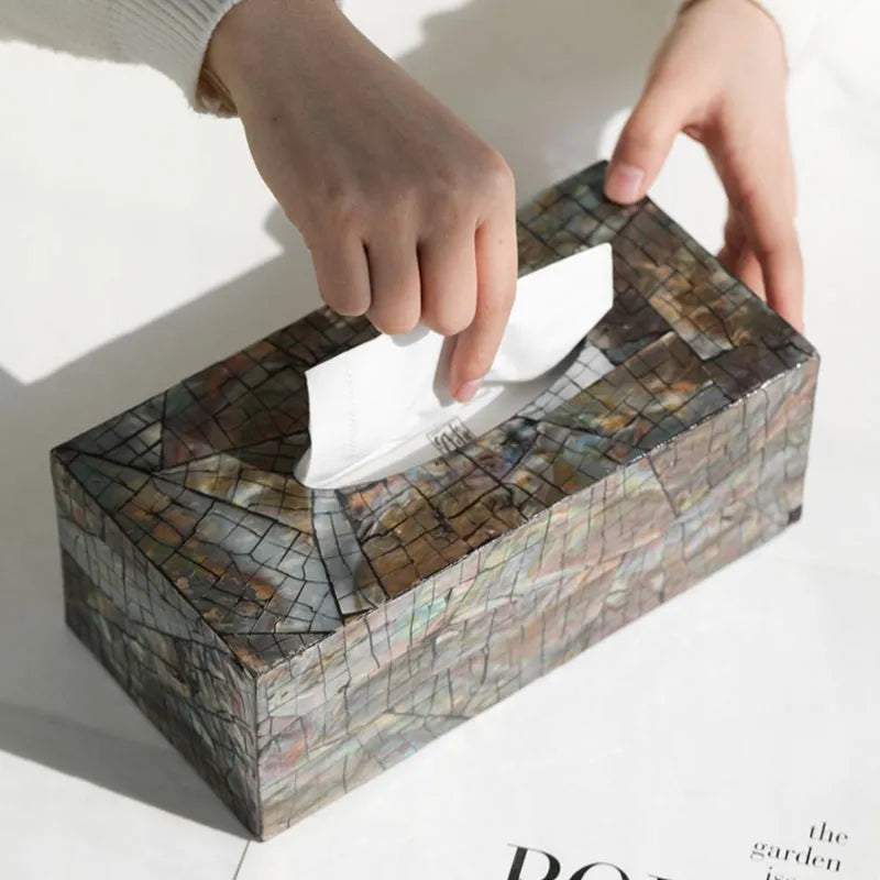 Black natural shell tissue storage box in rectangular and square shape options on a coffee table.