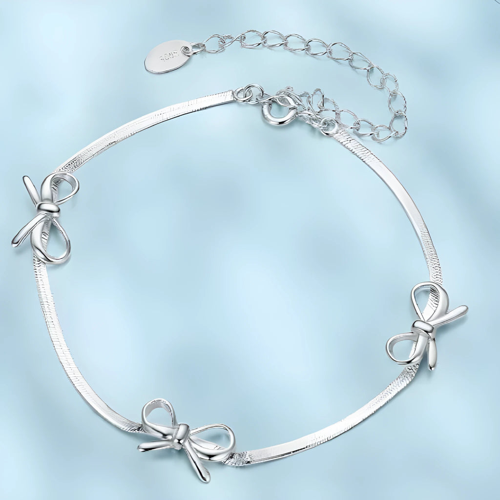 Sterling silver bow bracelet with romantic fairy style on white background