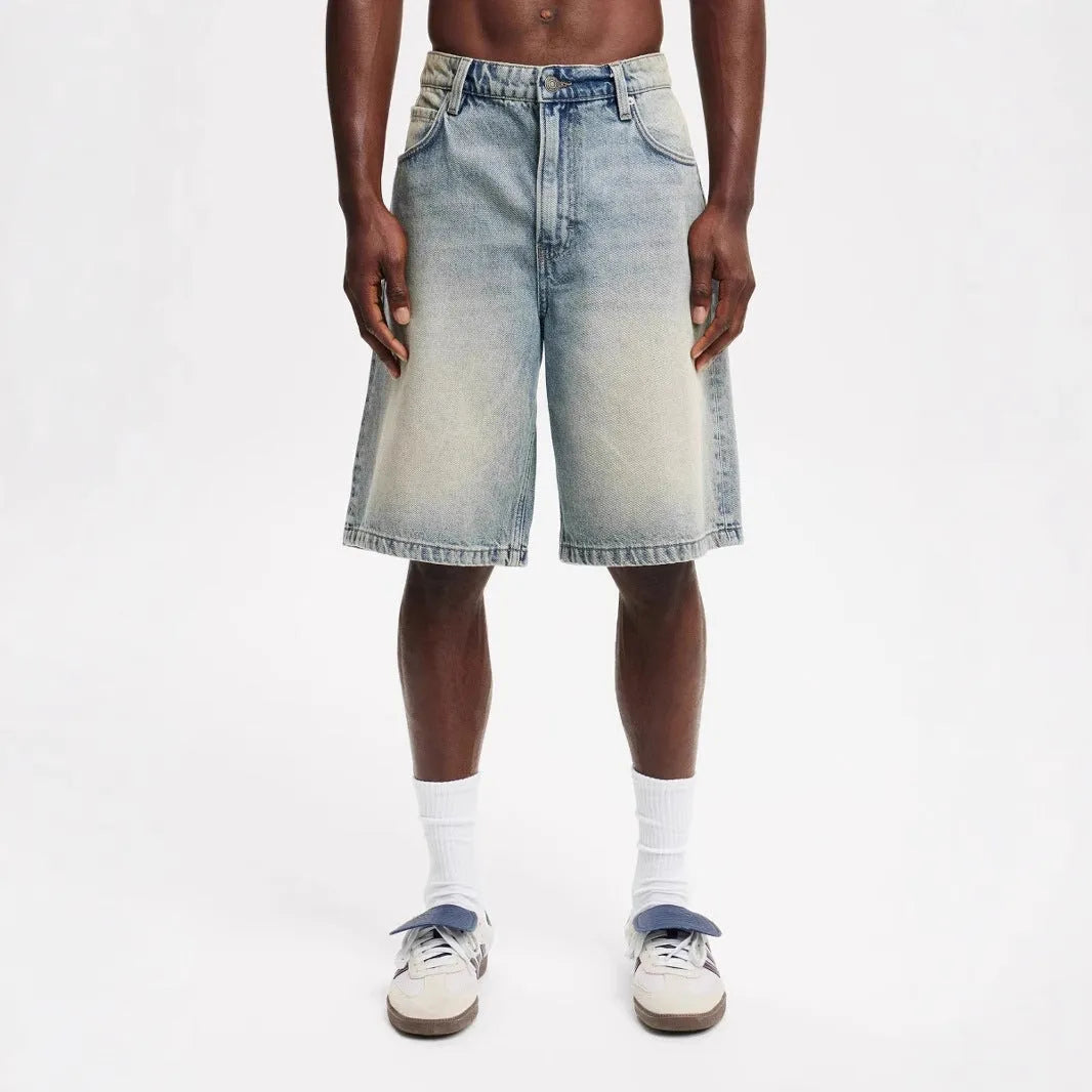 Men's loose straight-leg light blue cotton denim jeans on a white background