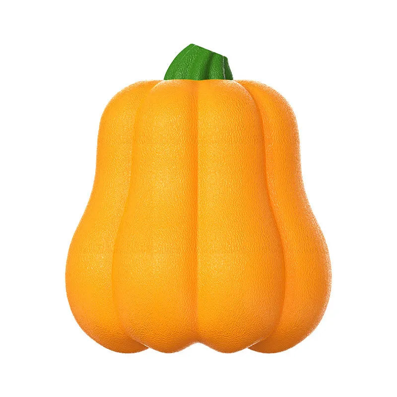 Orange plastic molar-shaped dog chew toy with rope, placed on grass for outdoor use.