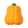 Orange plastic molar-shaped dog chew toy with rope, placed on grass for outdoor use.