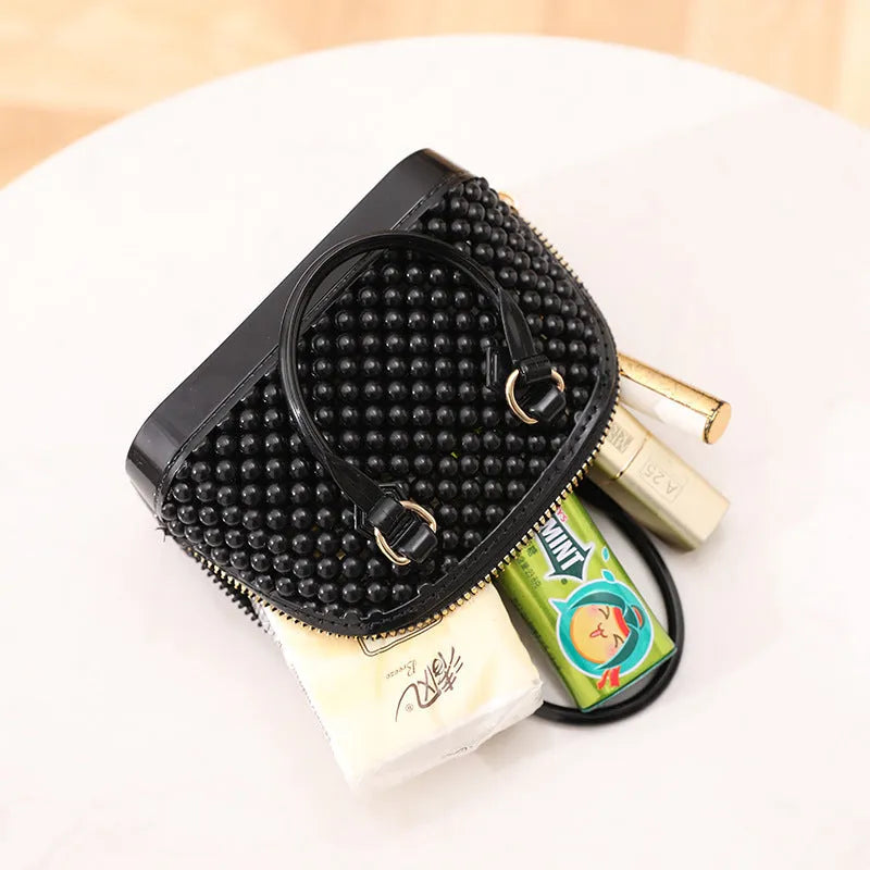 Translucent PVC jelly shell handbag with hollowed design and metal chain strap in apricot colour
