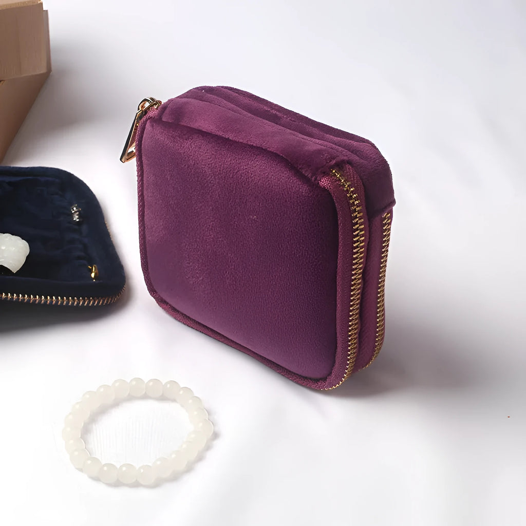 Blue PU zippered jewellery storage bag in handbag shape, 11x11x3.5cm, on a travel background