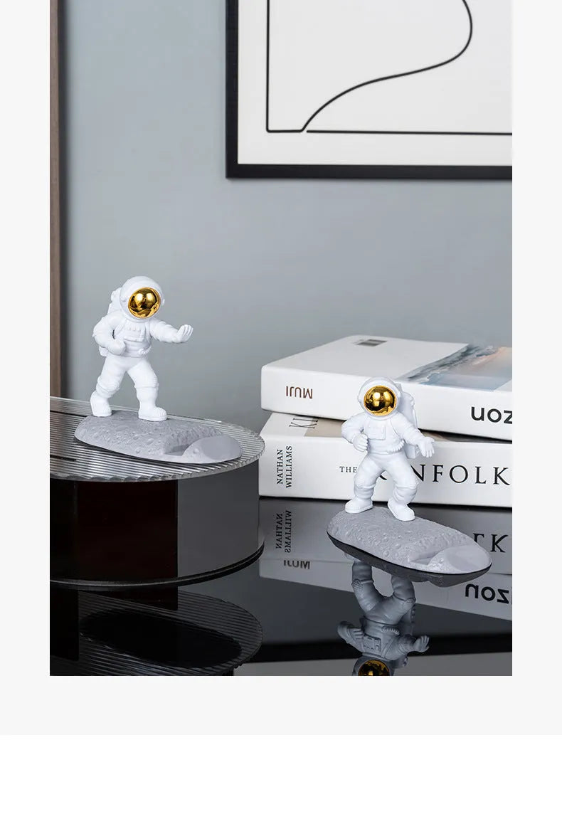 Astronaut decoration spaceman plastic mobile phone holder in blue, gold, and silver colours for lazy binge-watching