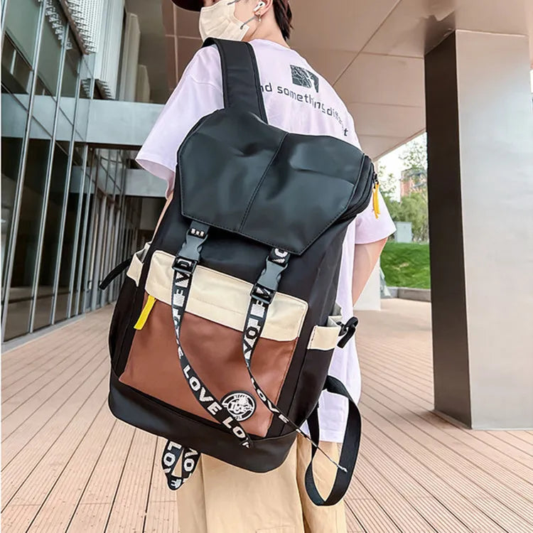 A black Oxford cloth backpack showing its size, carried over one shoulder.