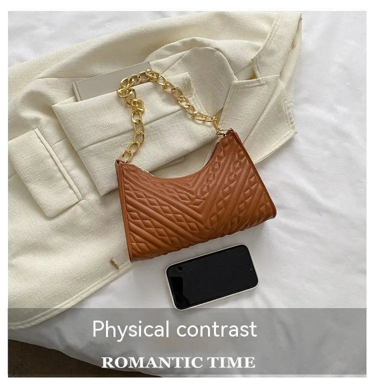 Brown pleated PU baguette shoulder bag with a top handle and long chain strap on a white background.