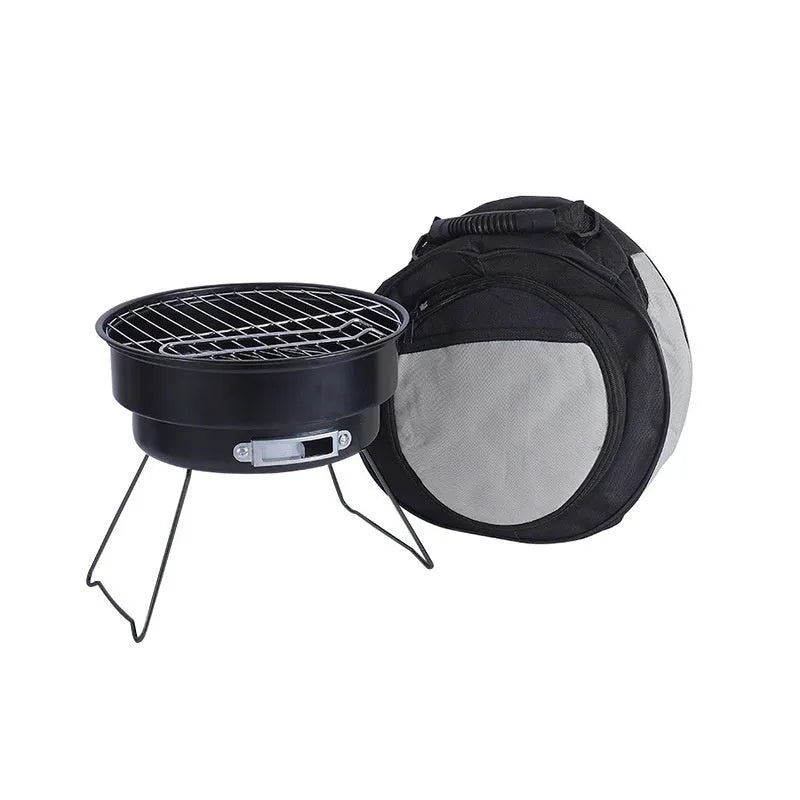 Small round folding metal ice stove with grill and foldable legs packed in a carry bag.