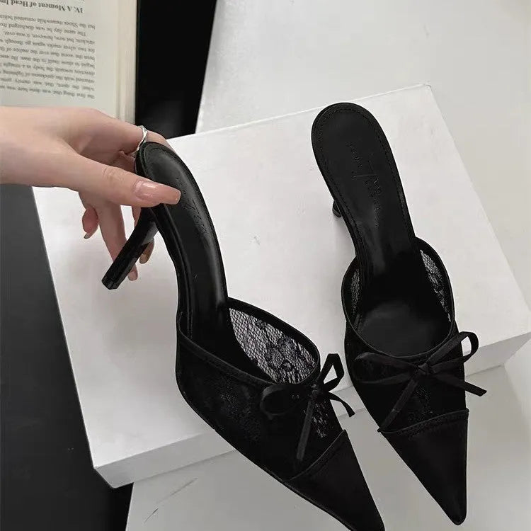 Women's light brown lace bowknot pointed toe high heels with mesh upper on a neutral background.