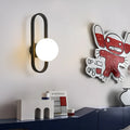Modern minimalist wall lamp with clear glass shade and black iron mount, showing three light colour settings.