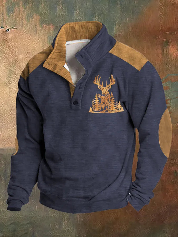 Man wearing a loose fit grey sweater with a blue 3D digital print pattern and four buttons down the front.