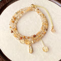 Gold electroplated women's bracelet with three interlinked circles made from natural caramel-coloured citrine and a Saturn decoration.