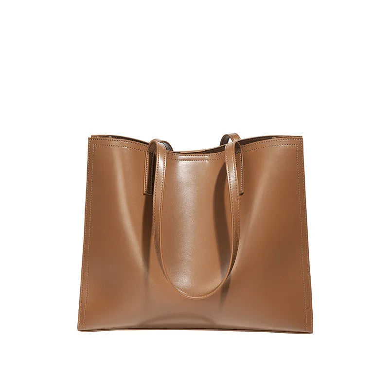 Brown genuine leather women's handbag with single shoulder strap and horizontal square shape