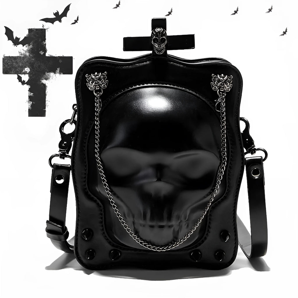 Black vertical square mini crossbody bag with embossed skull design, metal chain strap, and zipper closure
