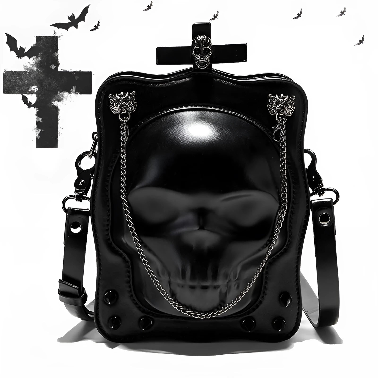 Black vertical square mini crossbody bag with embossed skull design, metal chain strap, and zipper closure