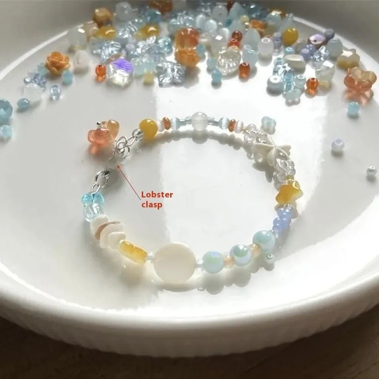 Orange alloy charm bracelet for women with a diamond-shaped charm and round bead details on a silver-tone chain.