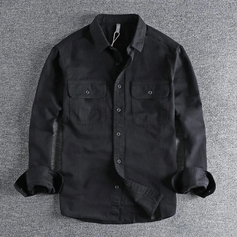 Man wearing a loose-fit light grey long sleeve cardigan-style shirt made from polyester.