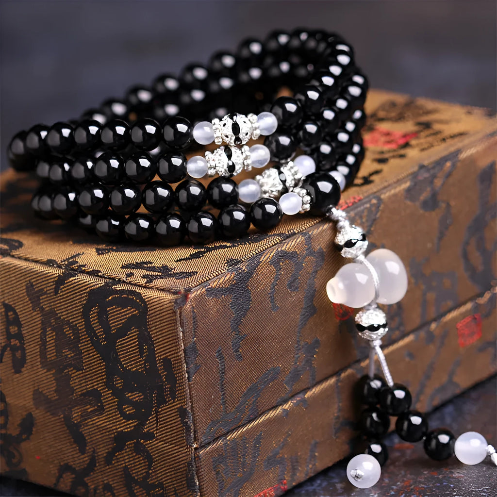 Black and red agate stone bracelet with 108 geometric beads on a wrist
