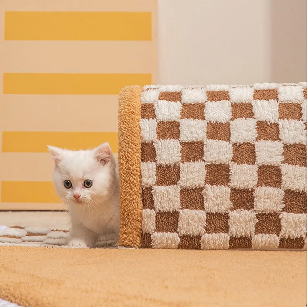 XL fan-shaped plush pet bed with a tunnel, in a plaid coffee colour, on a wooden floor.