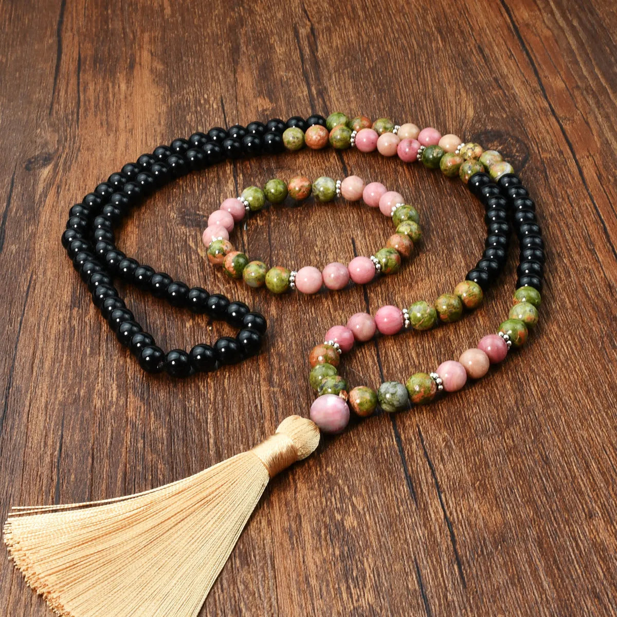 Natural unakite stone 108 prayer beads mala necklace and matching bracelet on neutral background